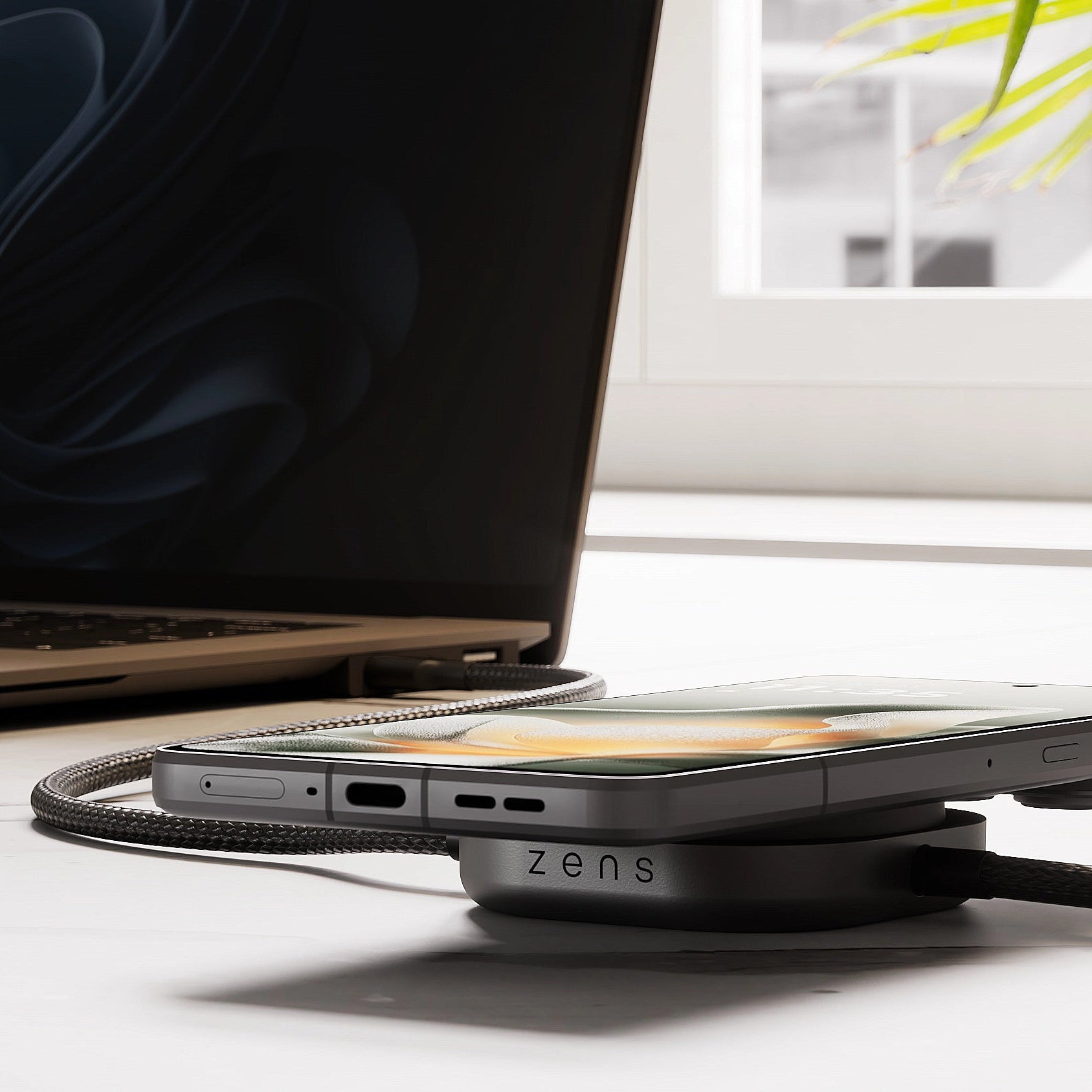 USB C Pro 2 charging cable charging a laptop and a magnetic smartphone.