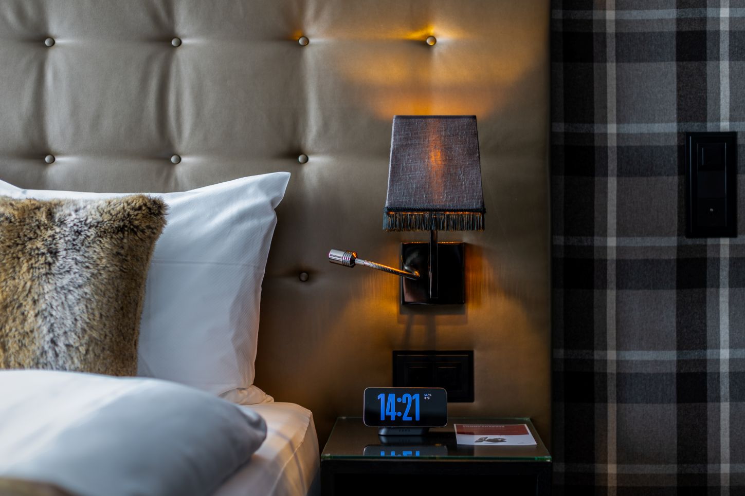 Magnetic nightstand wireless charger charging an iPhone with clock on a nightstand