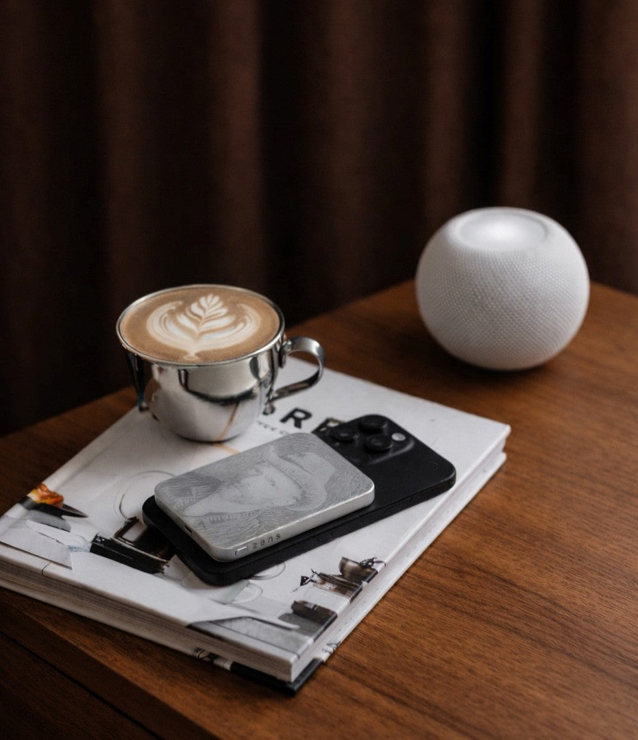Customized Van Gogh MagSafe power bank charging a smartphone in a lifestyle setting.