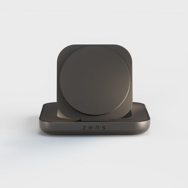 Zens Magnetic Nightstand Charger wirelessly and magnetically charging a smartphone displaying a clock.