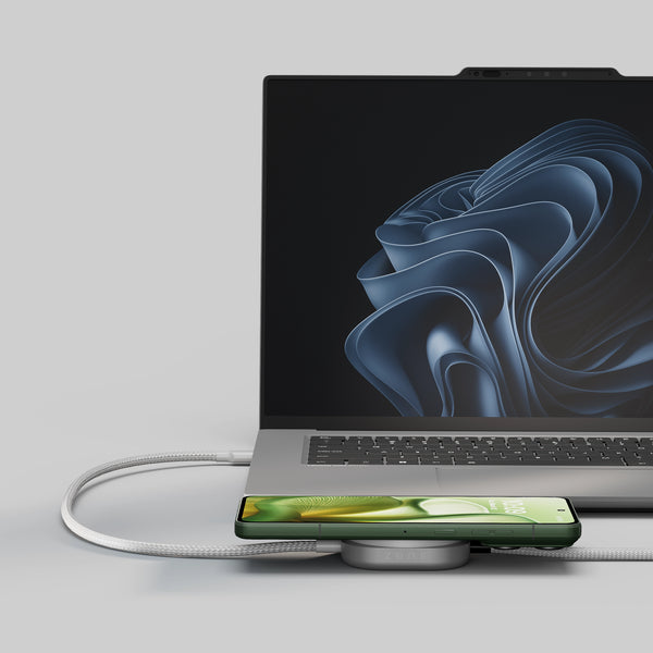 USB C Pro 2 charging cable charging a laptop and smartphone in a lifestyle setting.