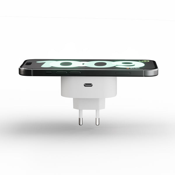 Plug in wireless magnetic charger charging a smartphone displaying a clock.