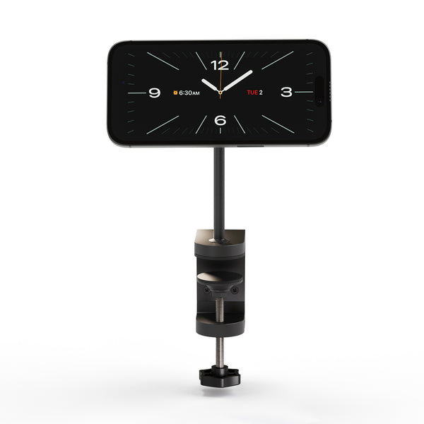 Zens Office Wireless Charger Mount Pro 2 magnetically and wirelessly charging a smartphone displaying a clock.