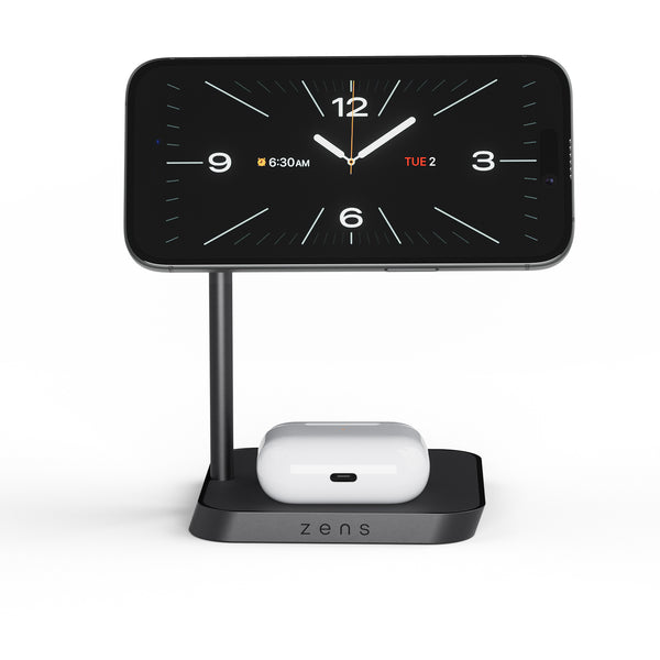 Zens Office Charger 2 wirelessly and magnetically charging a smartphone displaying a clock and AirPods.