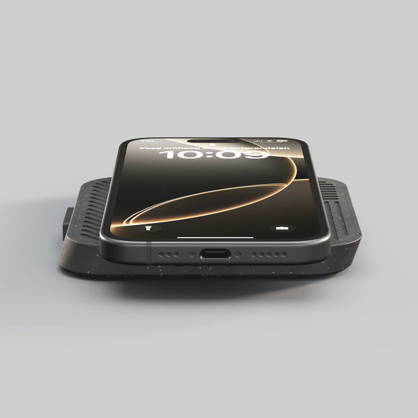 Zens Modular Single Wireless Charger Main Station wirelessly and magnetically charging a smartphone.
