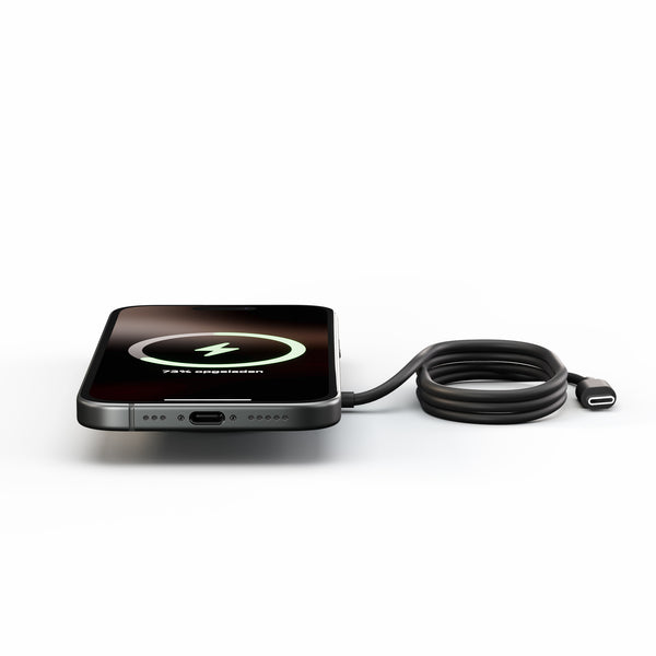 Zens Pro 1 magnetically and wirelessly charging a smartphone.