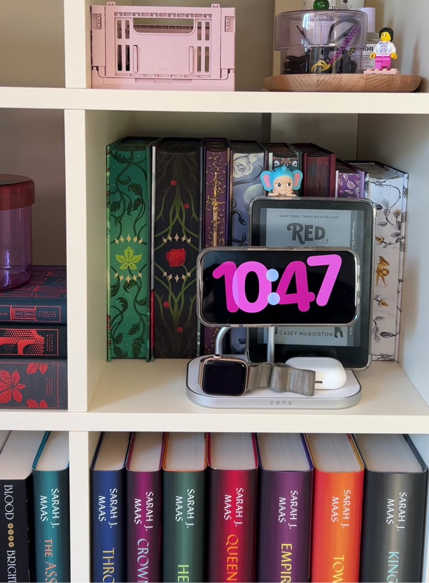 4 in 1 magnetic wireless charger charging a smartphone, AirPods, Apple Watch, and an e-reader in a lifestyle setting.