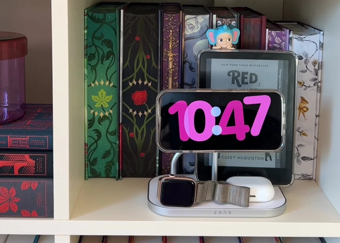 4 in 1 magnetic wireless charger charging a smartphone, Apple Watch, AirPods, and an e-reader in a lifestyle setting.