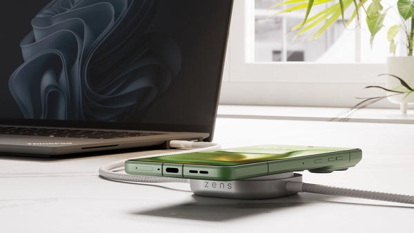 USB C Pro 2 charging cable charging a laptop and smartphone in a lifestyle setting.