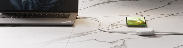 USB C Pro 2 charging cable charging a laptop in a lifestyle setting.