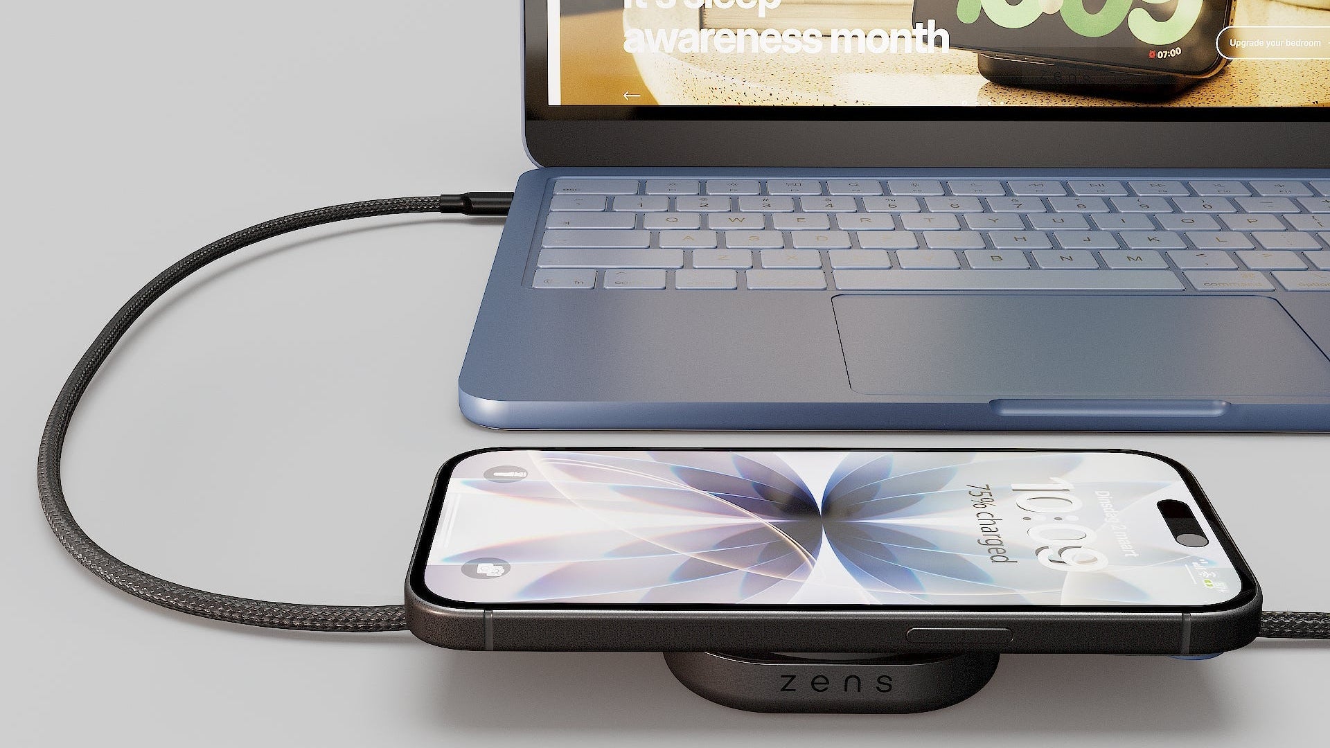 USB C to C charging cable and wireless charger powering a laptop and iPhone on a desk