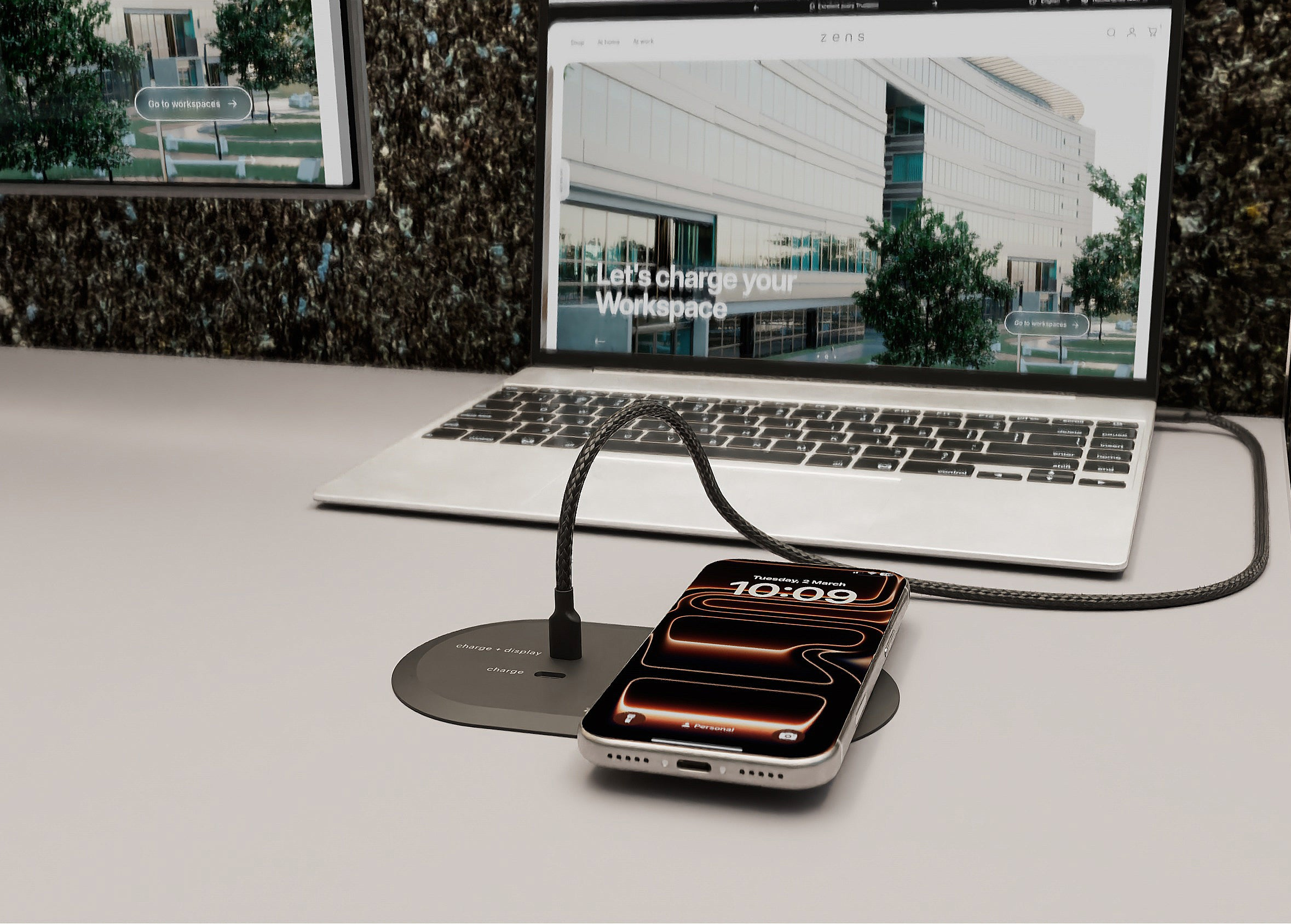 Zens PuK HDMI charging a smartphone with MagSafe and wireless charging in an office setting.