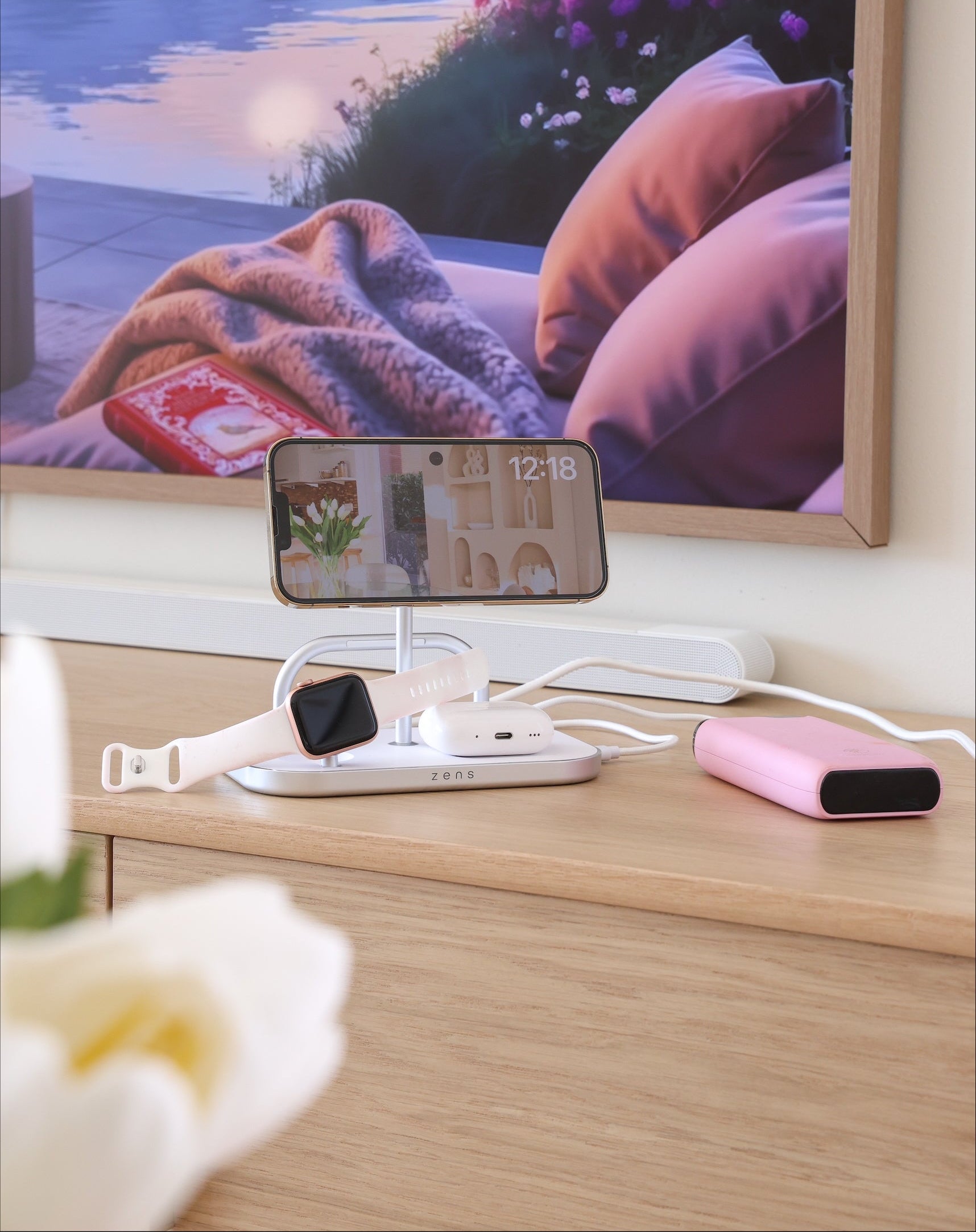4 in 1 wireless magnetic charger charging a smartphone, Apple Watch, AirPods and powerbank.