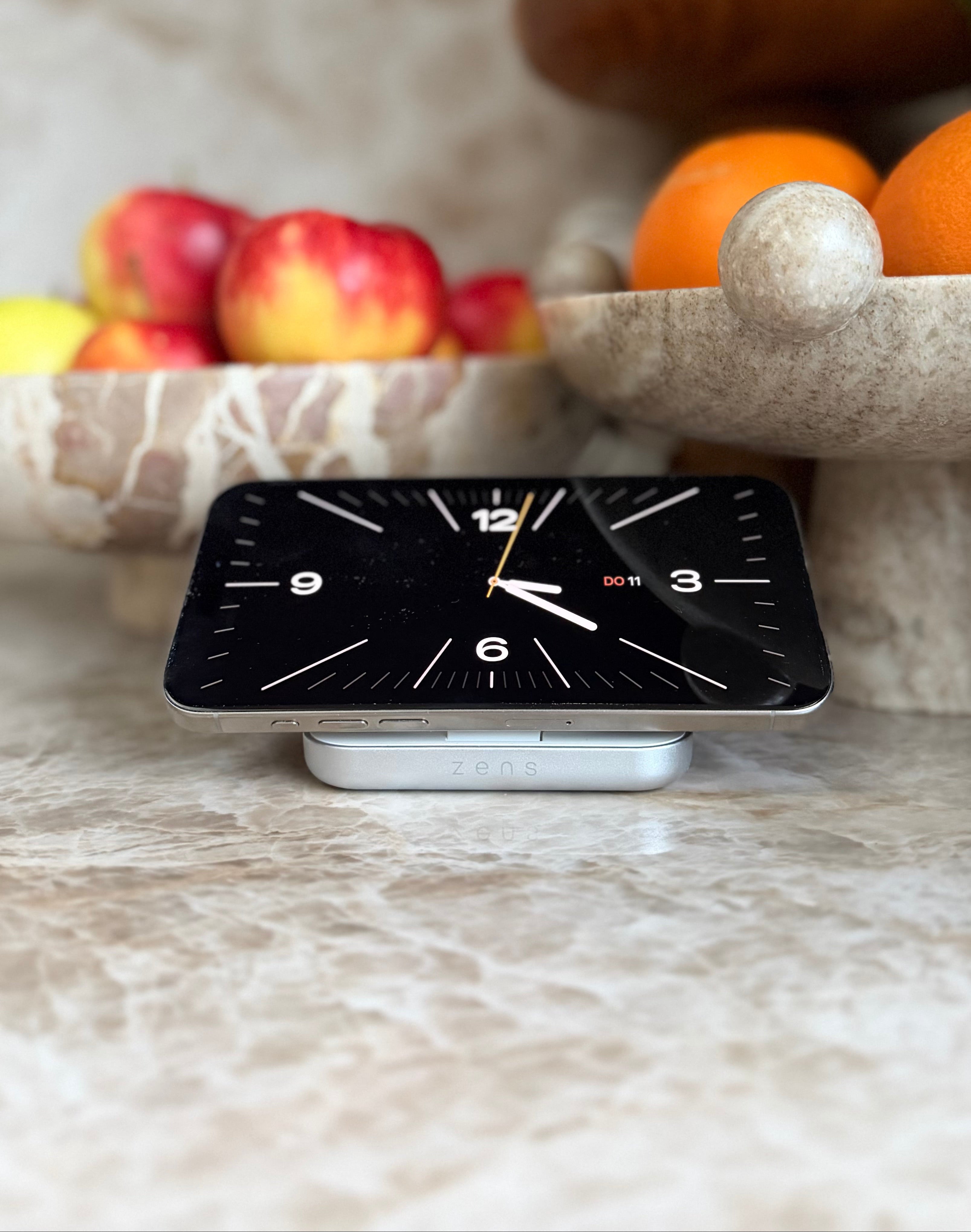 Magnetic Nightstand Charger wirelessly charging a smartphone displaying Apple StandBy mode with a clock in a kitchen.