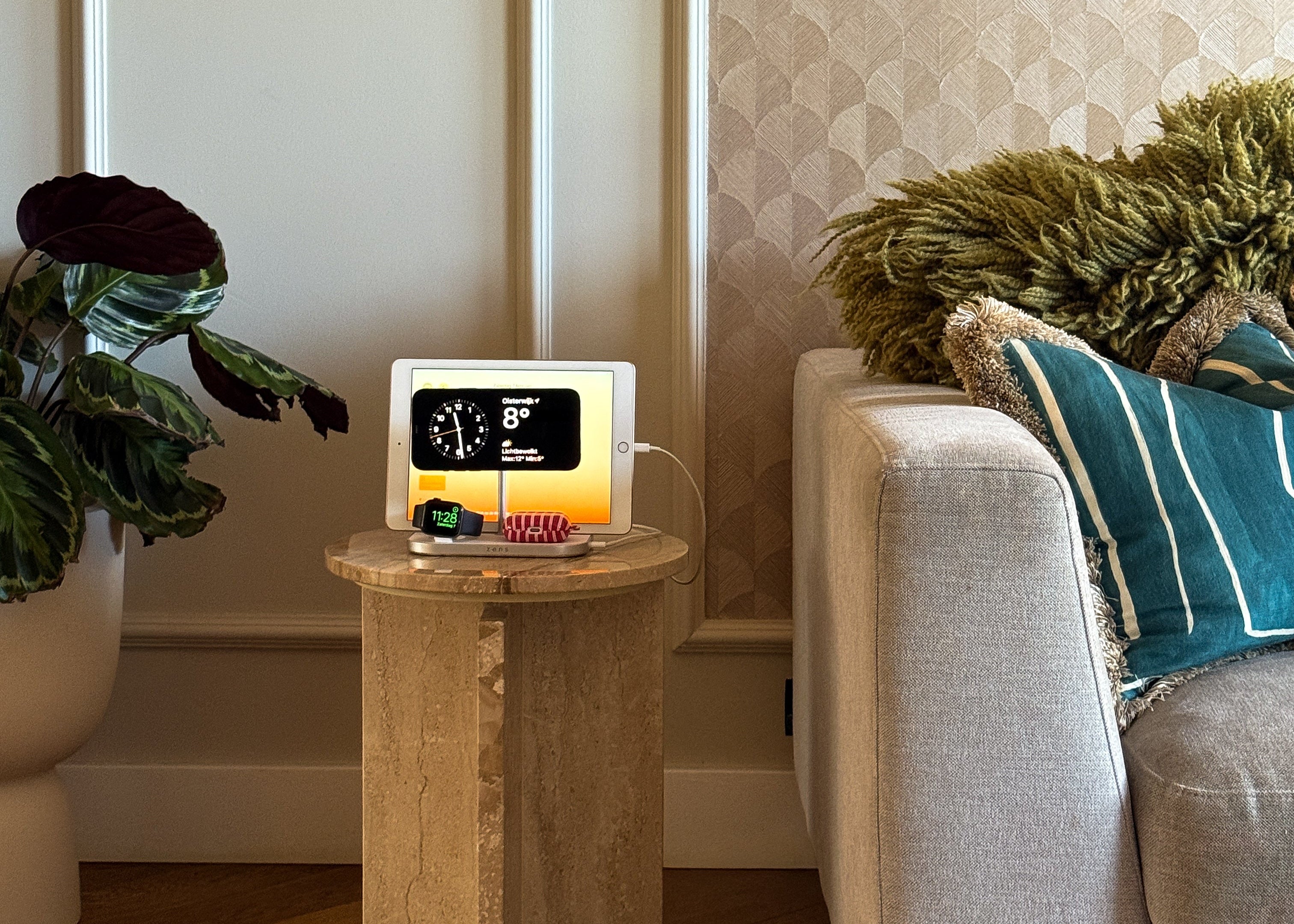 4 in 1 MagSafe wireless charger charging an iPhone, iPad, AirPods, and Apple Watch in a lifestyle setting.