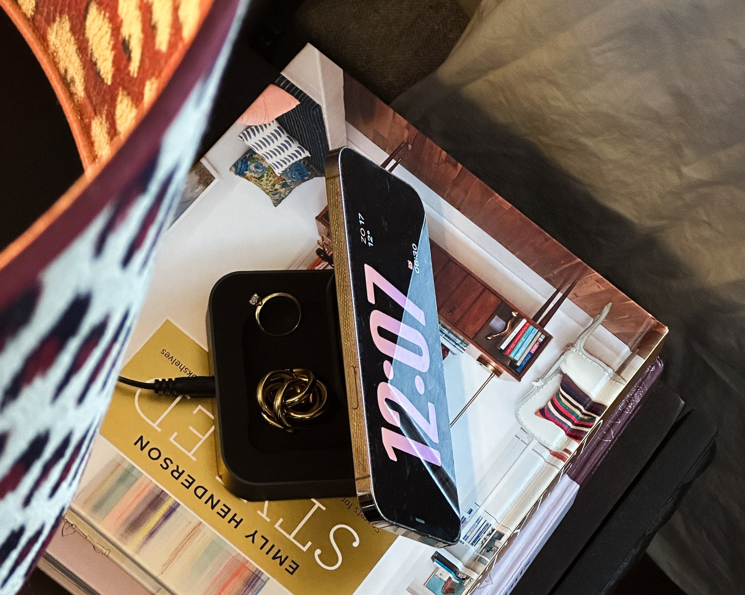Magnetic nightstand charger charging a smartphone on a nightstand in a lifestyle setting.