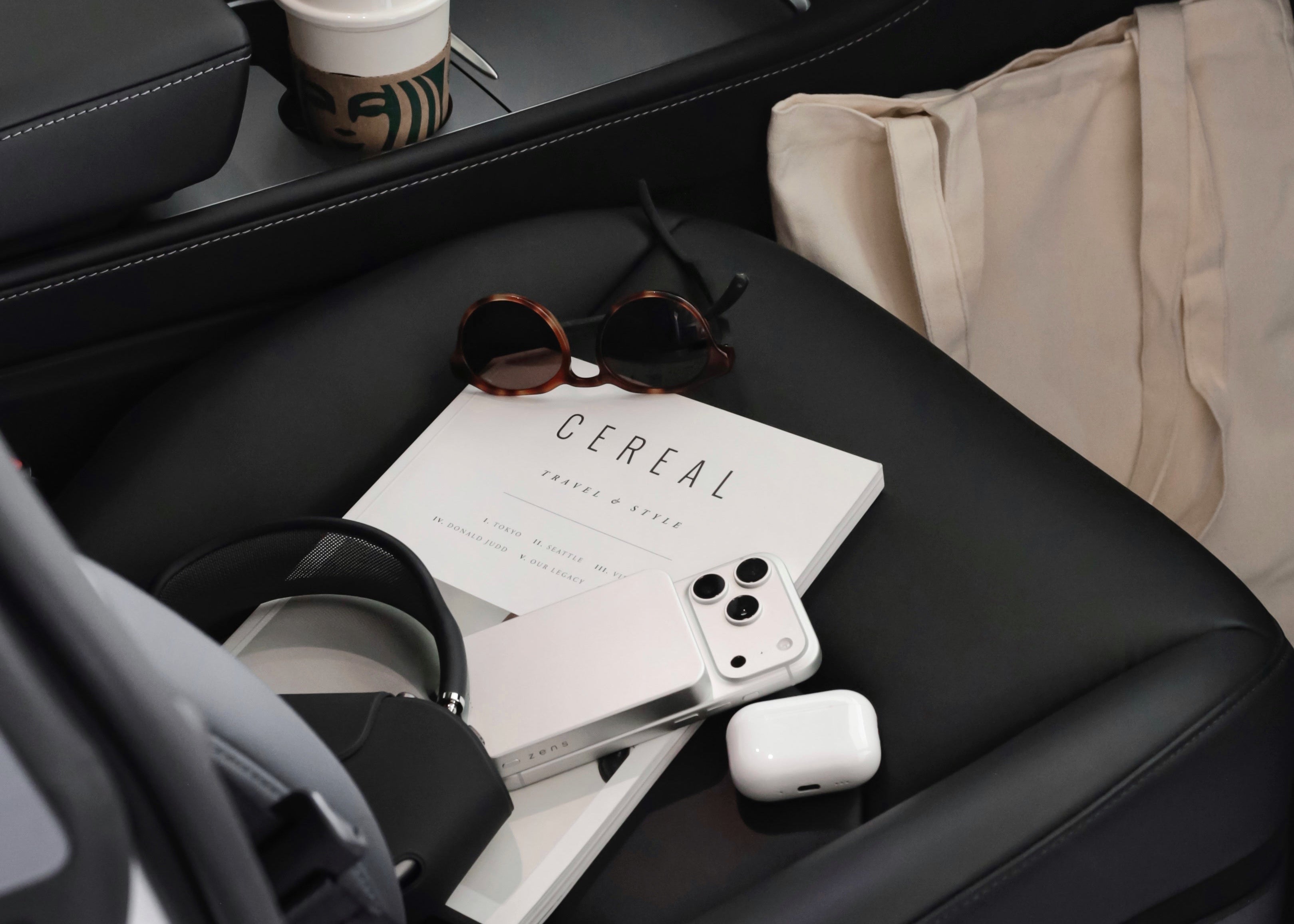 White semi solid state MagSafe power bank attached to and charging an iPhone in a lifestyle setting.