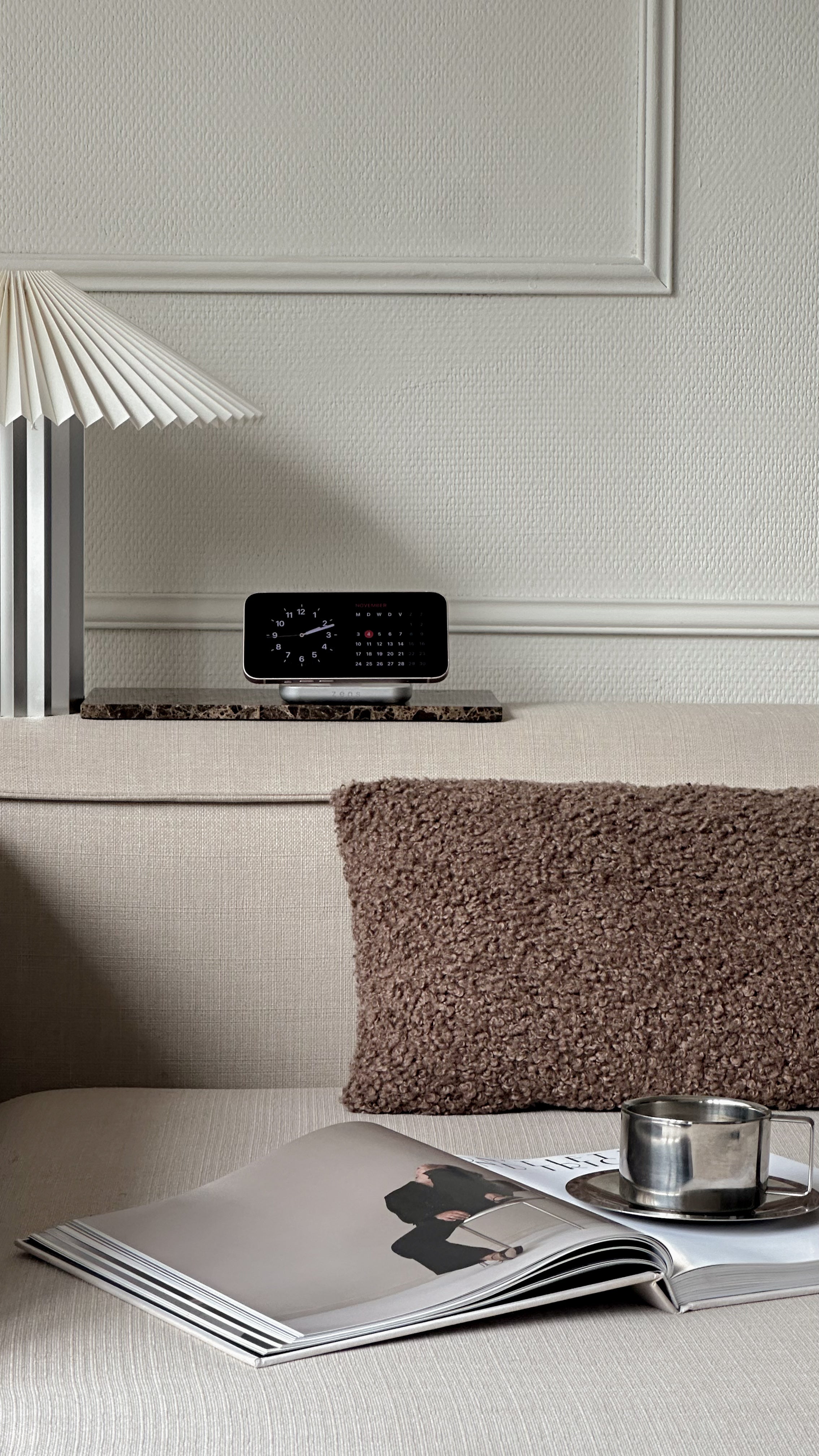 Magnetic Nightstand Charger wirelessly charging a smartphone displaying a clock in a lifestyle setting.