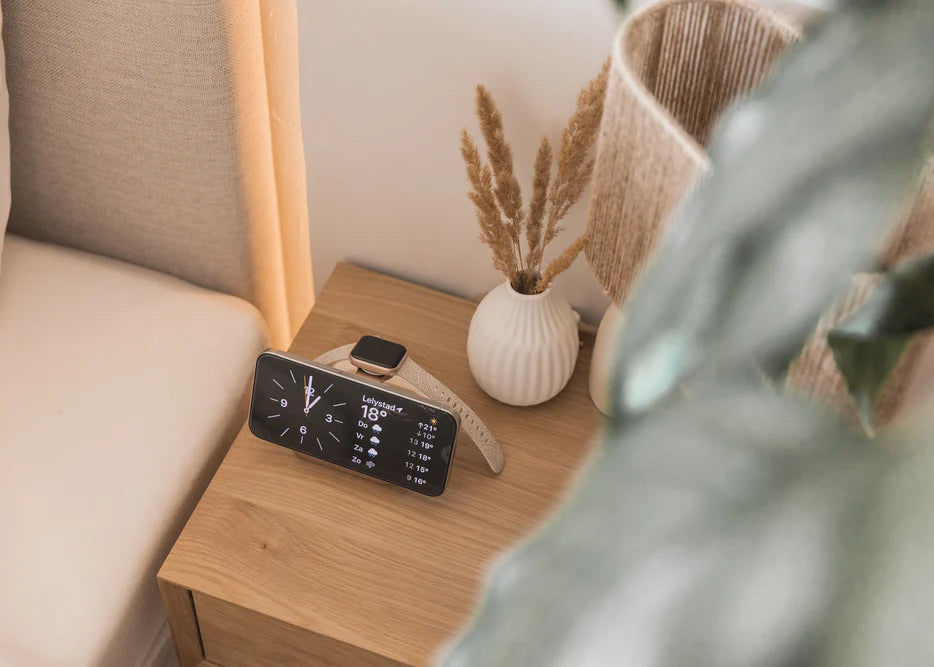 Wireless nightstand charger charging an iPhone and Apple Watch in a bedroom