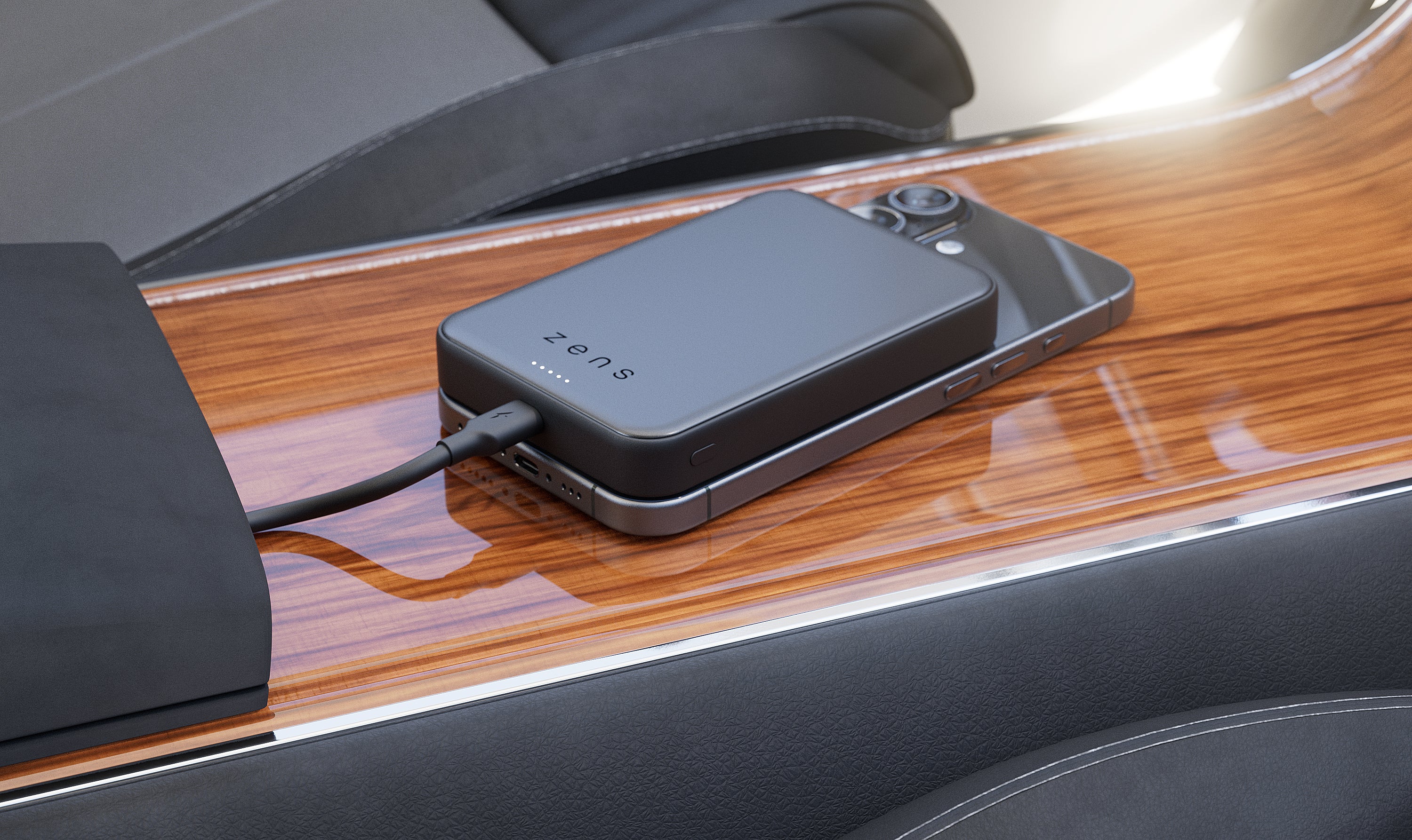 Zens magnetic wireless charger charging an iPhone in a car while the powerbank is being charged at the same time