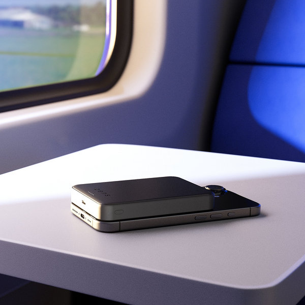 Zens semi solid state powerbank wirelessly charging an iPhone while traveling on a train