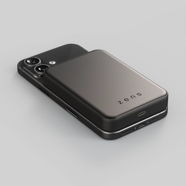 Zens semi solid MagSafe wireless powerbank charging an iPhone on a white background