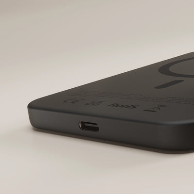 Close up of the black Zens magnetic wireless charger powerbank on a white background