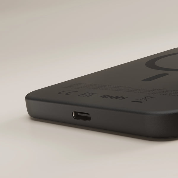 Close up of the black Zens magnetic wireless charger powerbank on a white background