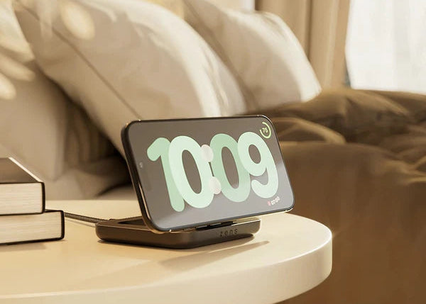 Zens nightstand charger magnetically charging an iPhone on a bedside table in a bedroom