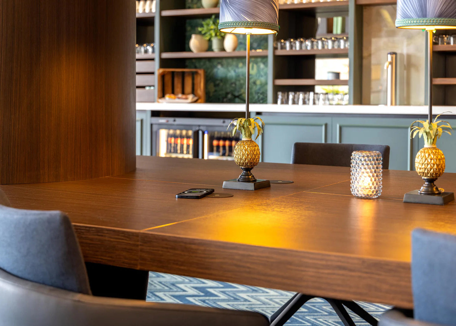 Zens VALK built in wireless charger integrated into a table charging a smartphone in a lifestyle setting.