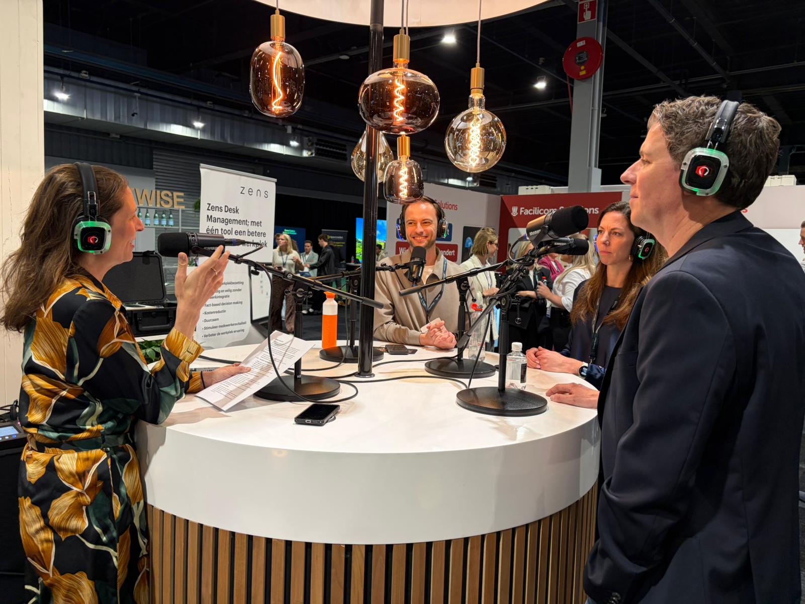 Ahrend Connect powered by Zens wireless charging solution in a podcast workplace experience setting.
