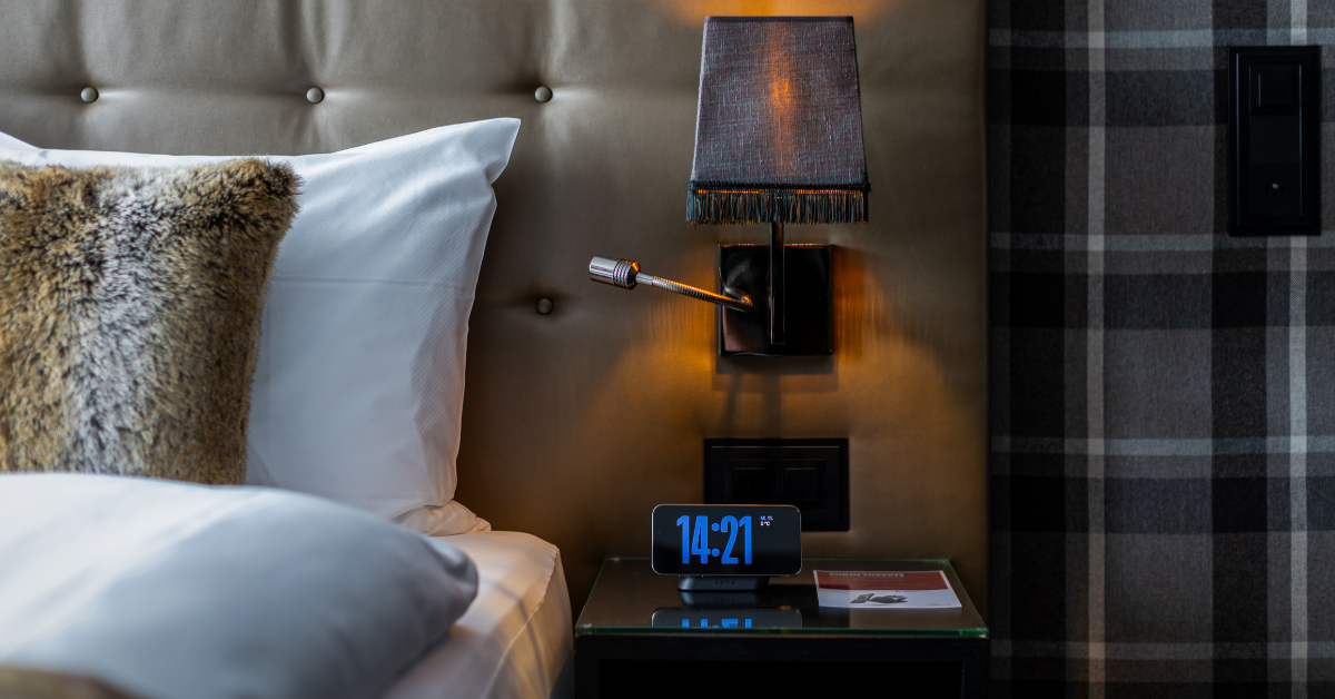 MagSafe Nightstand Charger charging a smartphone on a bedroom nightstand.
