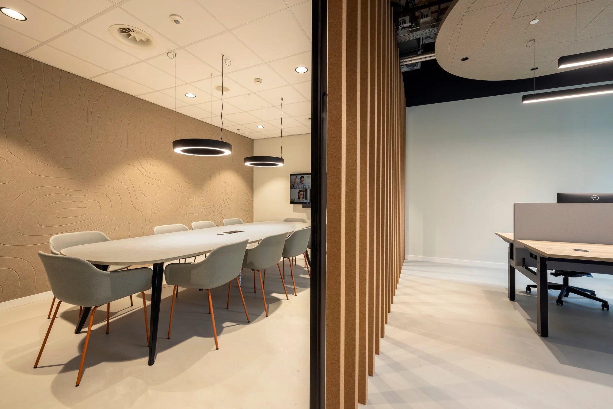 Wireless charger integrated into a meeting room table in an office.